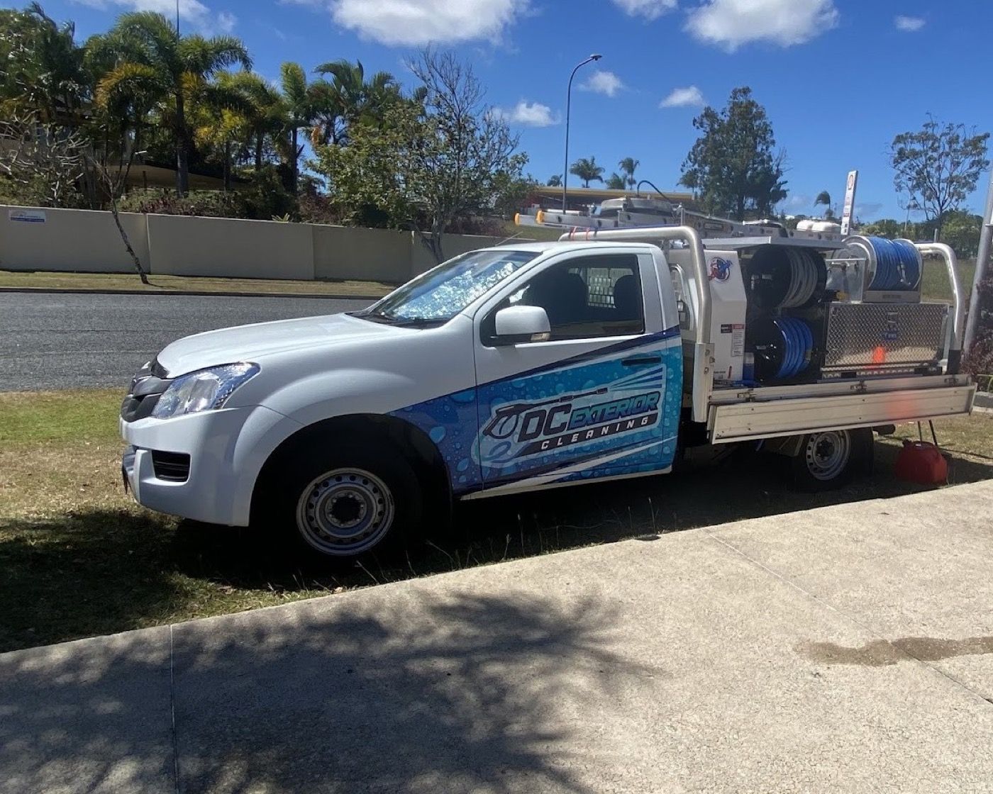The DC Exterior Cleaning ute with its pressure cleaning rig parked on a Mackay street