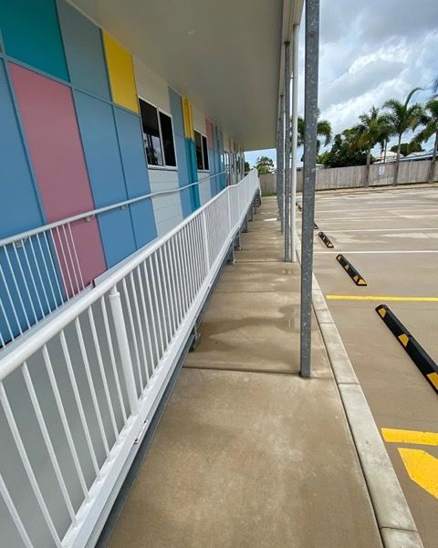 A covered walkway with painted panels at a childcare centre