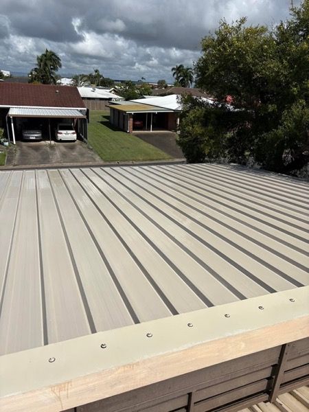 A metal roof with a cleaning hose running across it