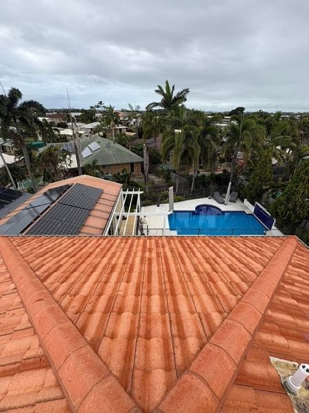 A terracotta tiled roof above a backyard pool