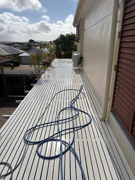 A long metal roof with a hose running along the length of it