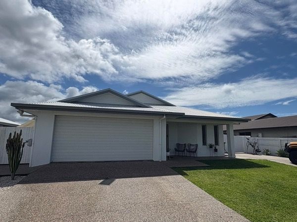 A modern lowset home with a wide driveway
