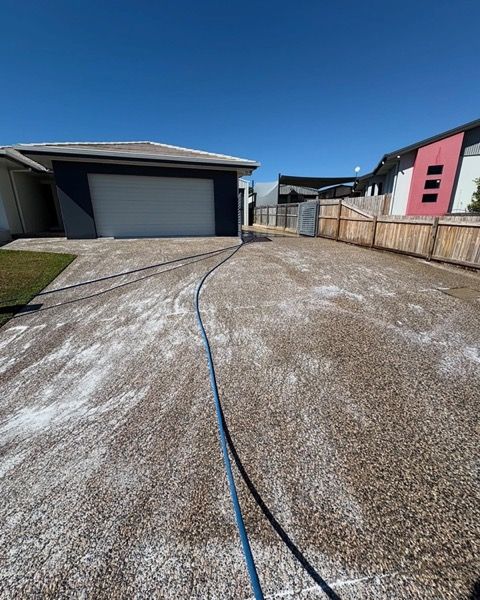 A concrete driveway with a hose stretched across it