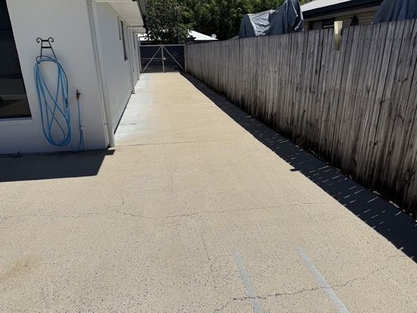 A concrete path beside a timber fence
