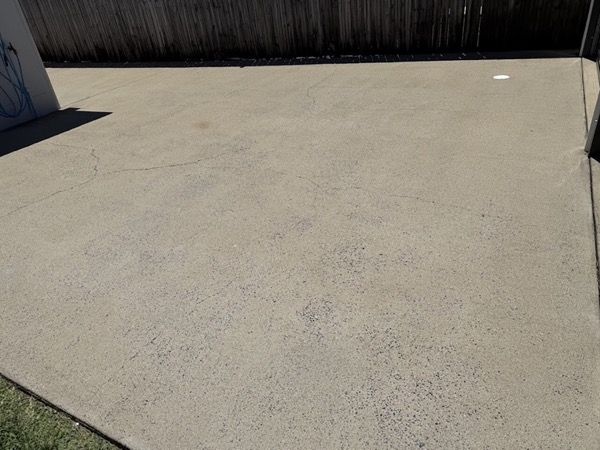 A concrete slab beside a colorbond fence